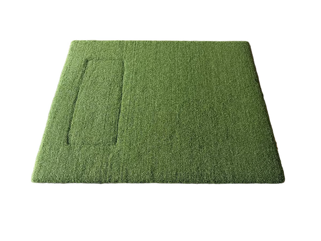 Green artificial grass mat on a concrete floor