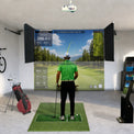 SkyDrop motorized golf simulator enclosure, ceiling-mounted drop-down screen in use