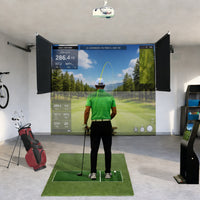 SkyDrop motorized golf simulator enclosure, ceiling-mounted drop-down screen in use