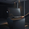 24 inch FHD 24/7 touch monitor mounted on a dark control console with a user operating the touch screen